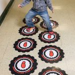 Elementary student walks on a sensory floor.